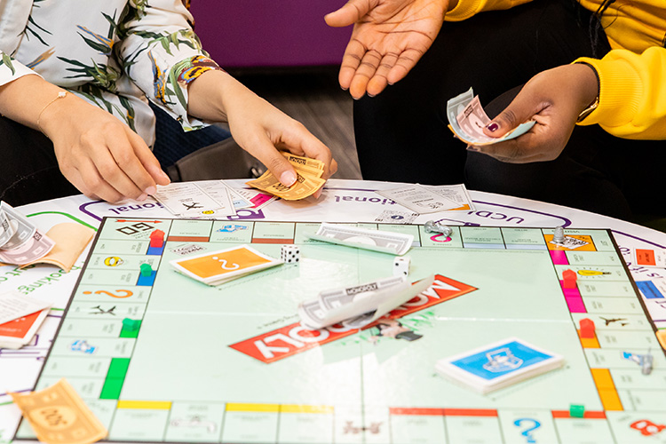 Hands playing Monopoly